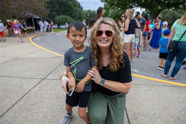 mom and boy student smiling in parking lot